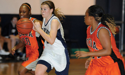 Junior Lydia Kline takes on two Cocoa High School defenders in a 2012 game.