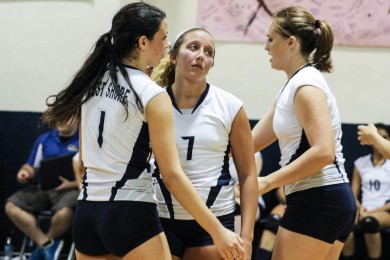 Juniors Kasi West, Taylor Kelley and Kaitlin Inganna meet after a point, in a district match against Edgewood on Aug. 27