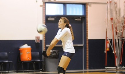 Erica Lobmeyer, 10, returns a warmup serve in a junior varsity game from 2012.