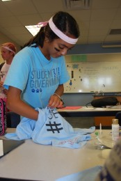 Despite dealing with the tardiness of Powderpuff shirts, junior Marissa Patel finds time to decorate hers.