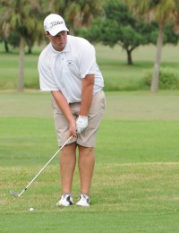 Sophomore Richard Darnell lines up a shot at Crane Creek Golf Course on Monday.