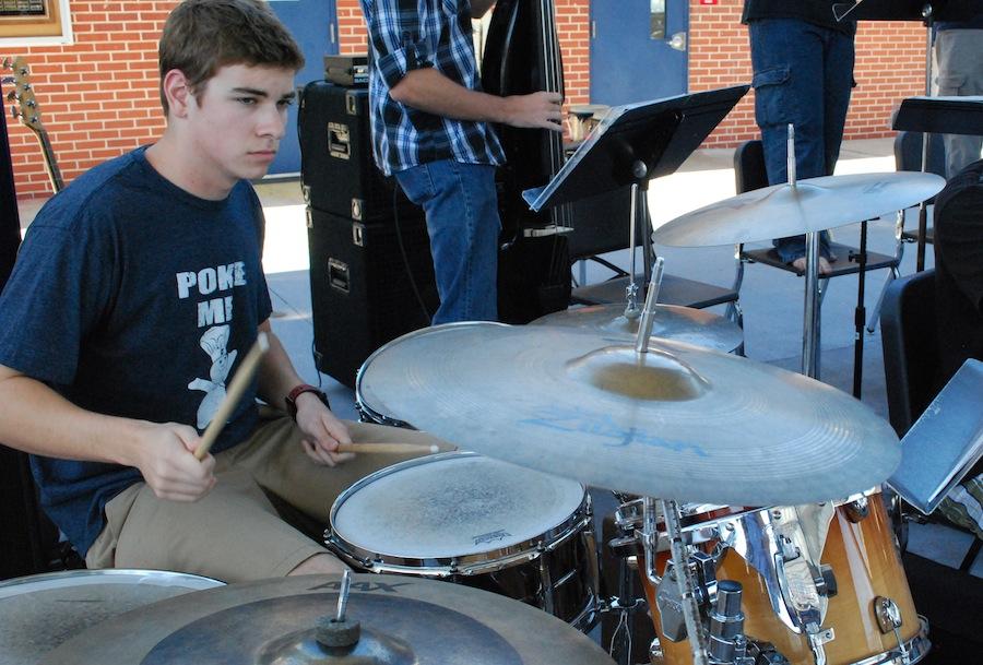 Senior Patrick Furino performs in the school commons area with members of the jazz band.