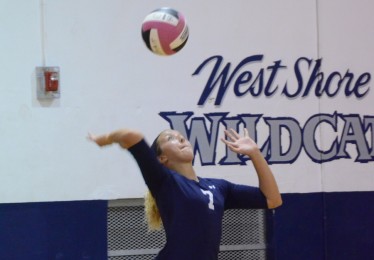 Junior Taylor Kelley serves during a home game.