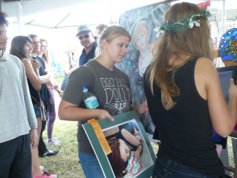 With finalists announced, senior Genna Owen helps to gather senior Samantha Grants art for the second round of judging.