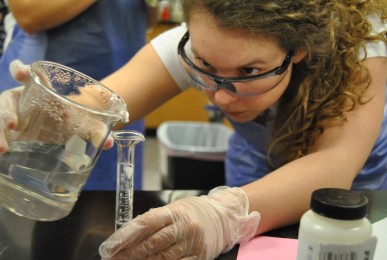 Concentrating, senior Carissa Sage prepares the experiment for transport to the ISS.