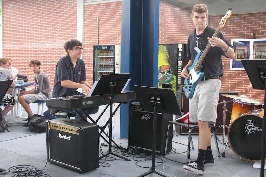 During a lunchtime performance, senior Daniel Tenbusch directs the jazz band, including senior Patrick Furino. Tenbusch will conduct the pit orchestra for Brigadoon.