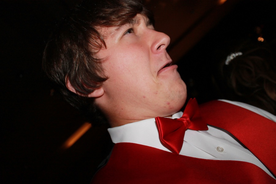 Face contorted, junior Connor Courtney dances at Prom.