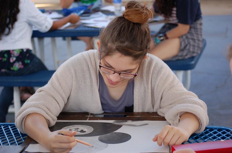 Sketching off of a photograph, tenth grader, Kayelee Embry puts the finishing touches on her still life classroom project. “I’m so happy to be able to include my love for Disney within an actual class at school,” said Embry. 