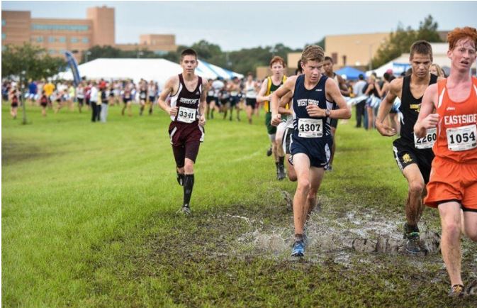 Battling it out against opponents, Sophomore Tyler Adams (20:15 5K) competes in the flrunners.com Invitational 15 race. 