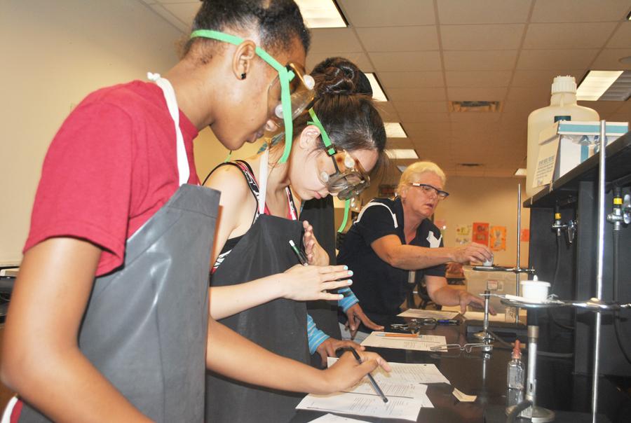 Former chemistry teacher Delilah Narvaez directs a lab in August.