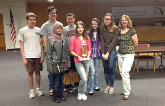 Front row: Anna Feldbush  and Fatima Hussein. Row 2: Daniel Borneman, River Grace, Caleb Bryant, Melinda Silaghi,  Molly Minta, Coach Angela Feldbush. 