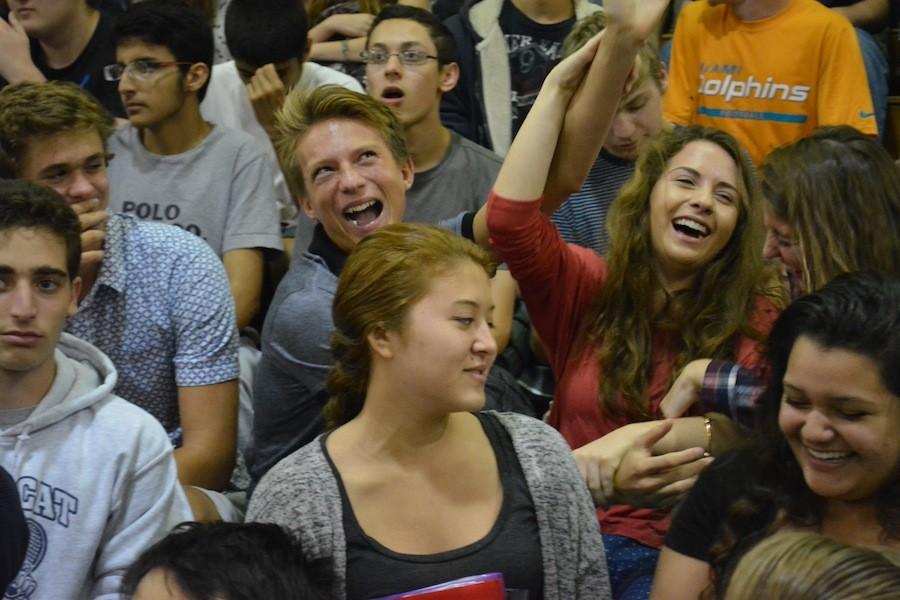 Juniors Connor Neff and  Callia Karas enjoy the entertainment at the winter-sports pep rally in November.