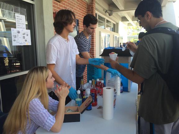 After school, juniors Jerry Sola, Gianni Valenti and Joanae Lawrence sell snow cones. 