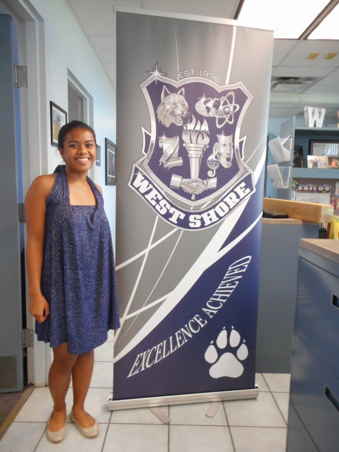 Senior Martina Parguian shows off her newly designed logo in the front office.