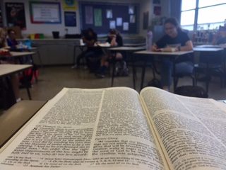 Fellowship of Christian Students kicks off a Friday meeting by reading from the Bible.