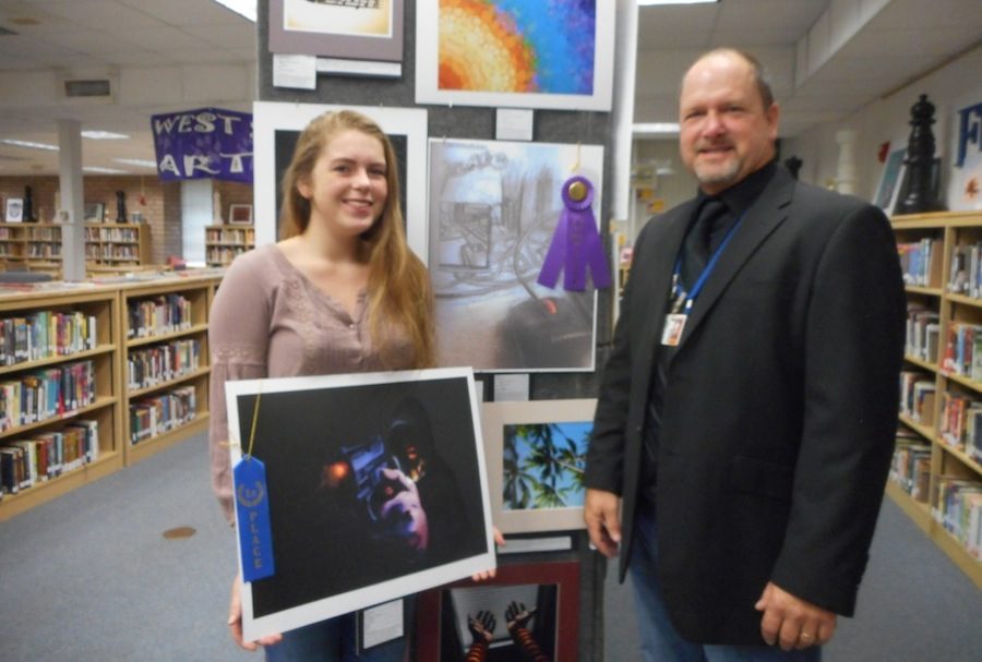 Senior Grace Bryant shows off her best in show piece as teacher Jim Finch looks on.
