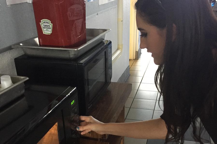 Senior Brianna Sandoval heats mac and cheese in one of the new microwave ovens Monday.