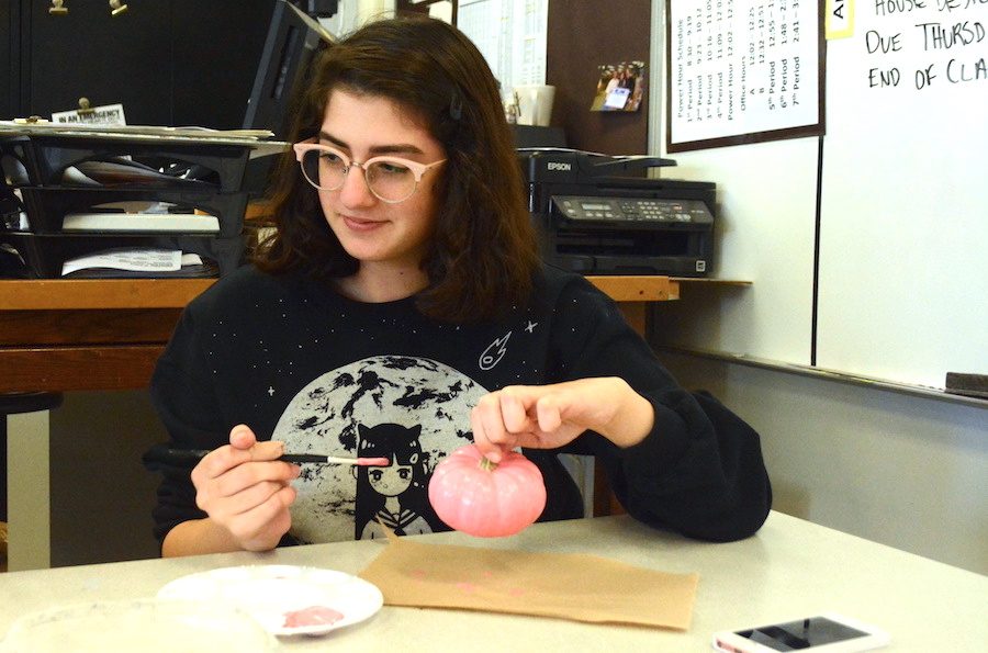 Senior Nikoleia Paterakis decorates a tiny pumpkin during last year's contest.