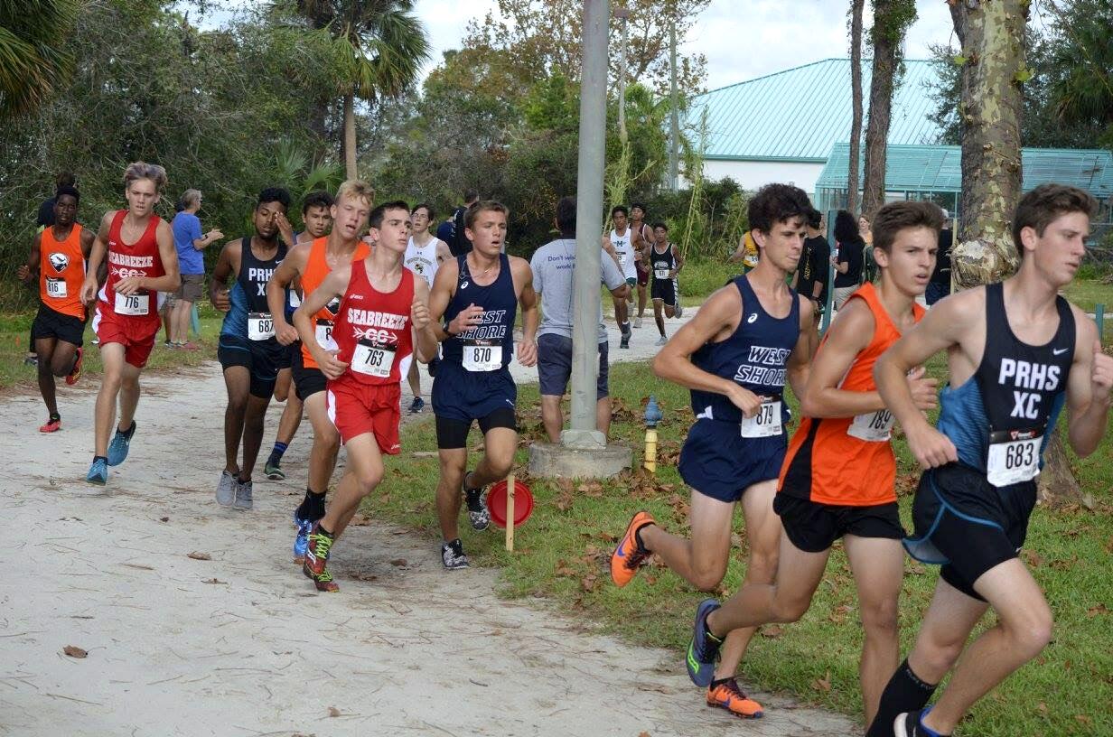 Sophomore Christopher Johnson and senior Adam Blackwell run at the Shark Classic Cross Country Meet.