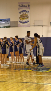 The team rallies around injured senior Khalil Paul before Tuesdays opening tip-off.