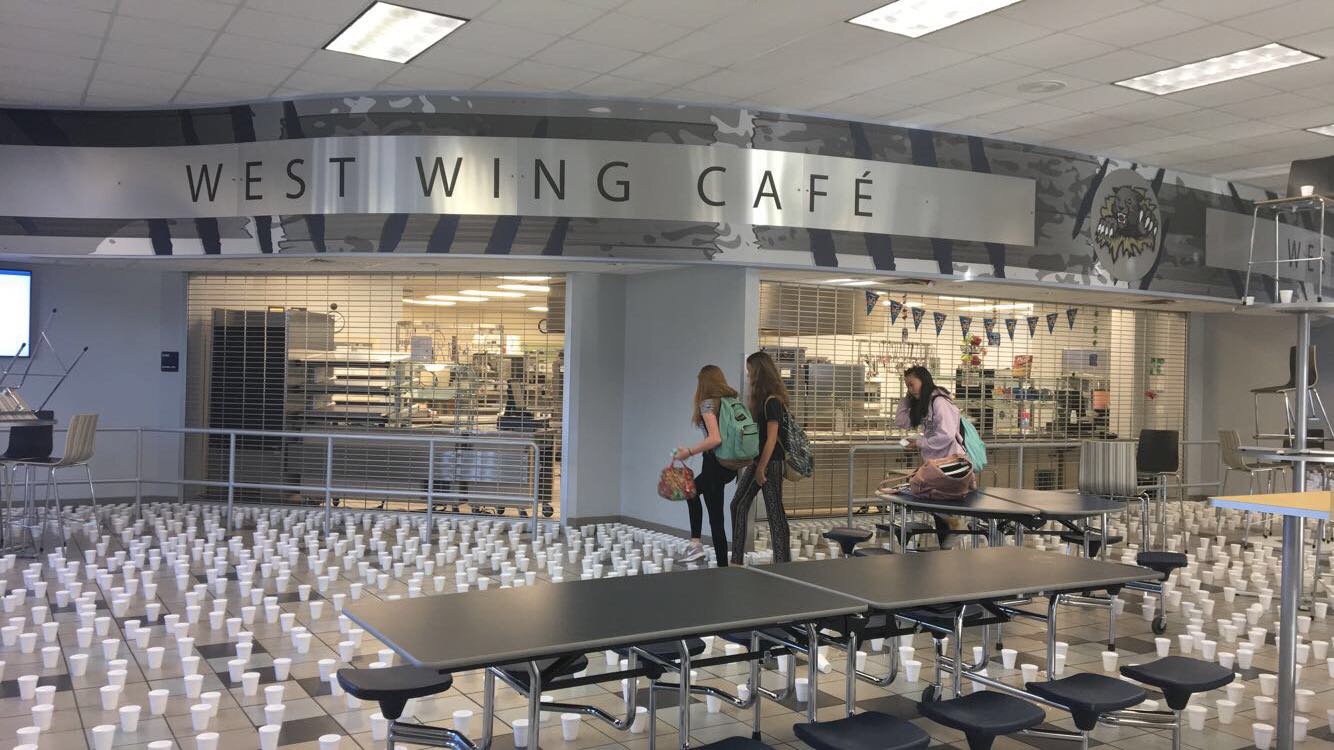 Caution: Wet Floor High-stepping over the hundreds of water filled cups placed at random on the cafeteria floor, seventh graders Alice S., Audrey D, and Shayla R. experience one of the many pranks played by the seniors. Keeping to tradition, the graduating class spent an estimated 3.5 hours setting up all the pieces of mischief the morning of May 4. Their various pranks followed the loose theme of mayhem, which included: the moving of desks out of classrooms, plastic-wrapping the school, stacking the lunch tables, and slicking the handles and railings with Vaseline.