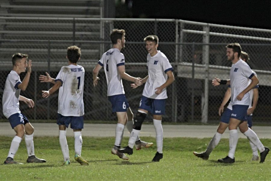 Seniors Collion Robidoux, Chase Hester, Conor Horn and Cameron Yuetter along with junior Matthew Rabel celebrate after a goal.