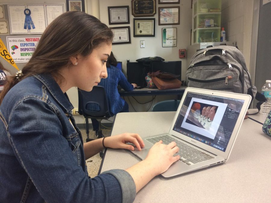 Junior Marlee Krause works on her submission to the art show.
