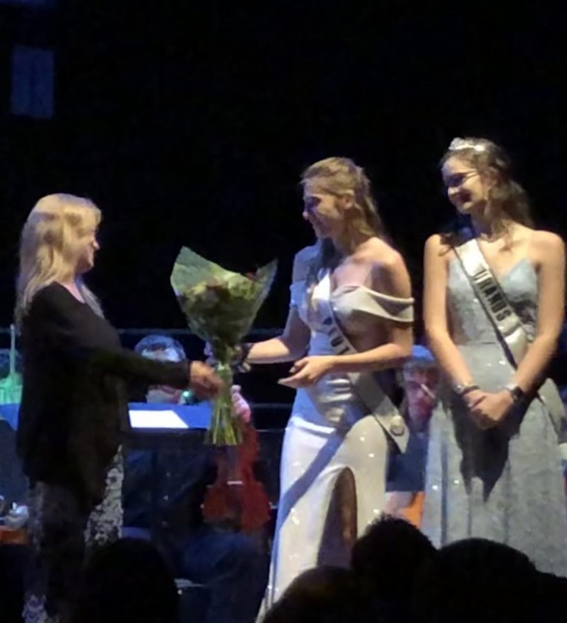 Strings consultant Laura Pinfield receives flowers at a 2019 orchestra concert