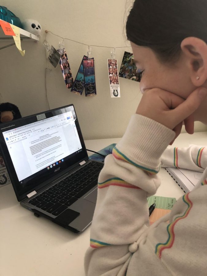 Amelia Bailly (7) revises an essay assignment for a virtual class.
