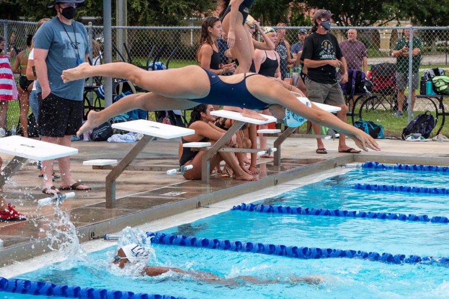 Girls team captain Layla Auter dives off the block and anchors the 400 free relay. 