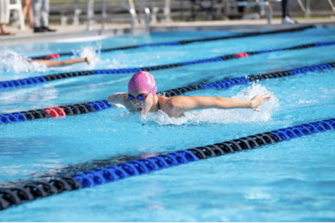 Sophomore Nicole Riopelle swims in a   100 butterfly race.