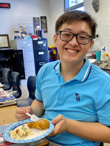 Joey Garcia (12) sits down to enjoy his food during the Harry Potter clubs last meeting. Club president Dana Zschau (10) and sponsor Tamara Reis provided the mash potatoes, toppings, and fried chicken, in addition to cookies, brownies, and cupcakes.