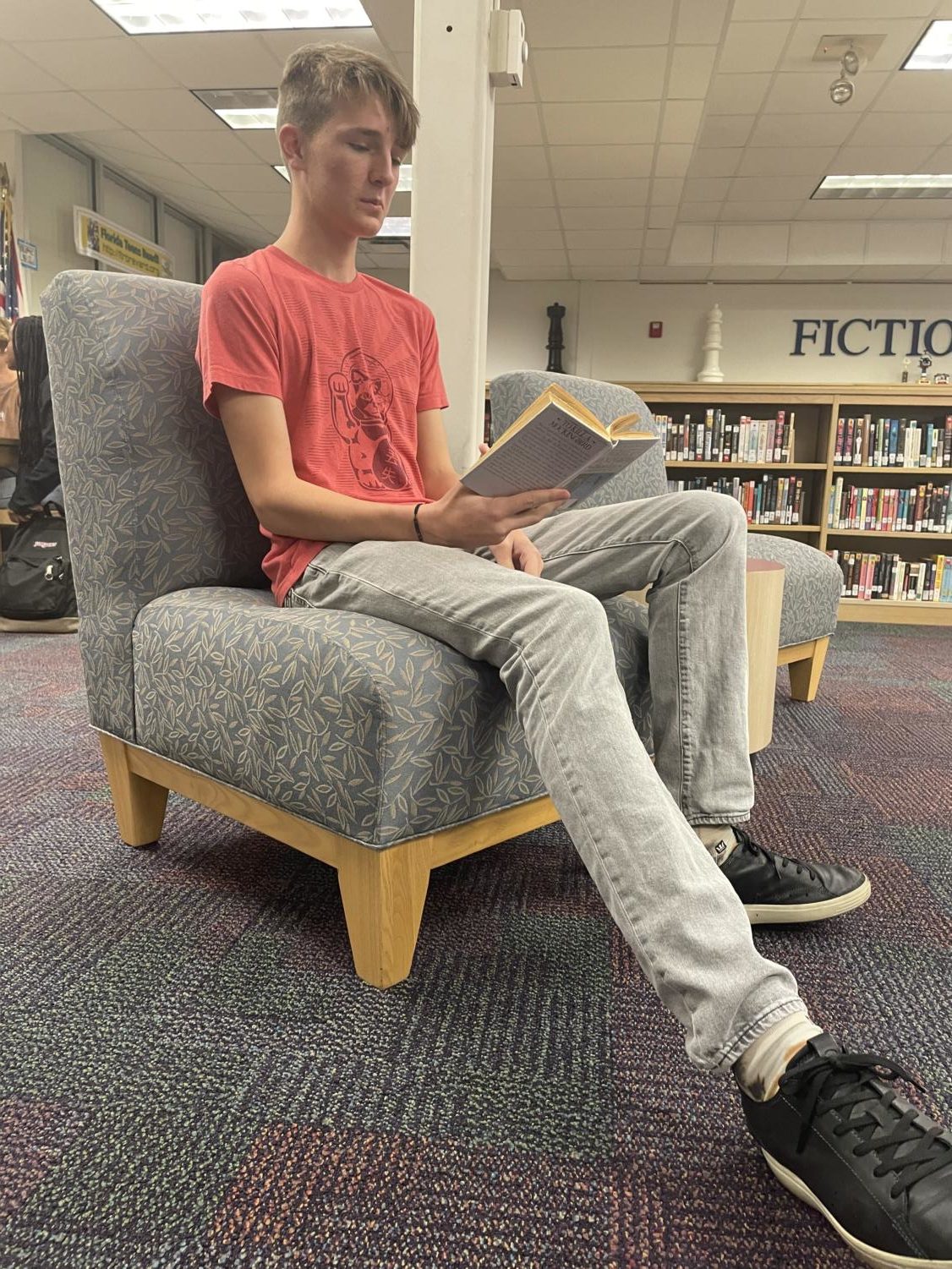 Freshman Francis Lewandowski reads Harper Lee’s To Kill A Mockingbird in the school’s media center.