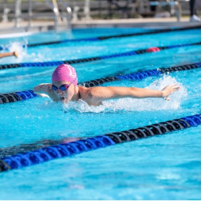 Sophomore Nicole Riopelle swims in a   100 butterfly race.