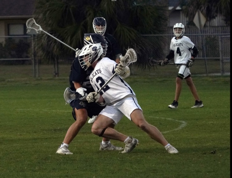 Zach+Johnson+and+Kody+Wessel+playing+a+game+against+Holy+Trinity+Episcopal+Academy+on+Feb.+23.+