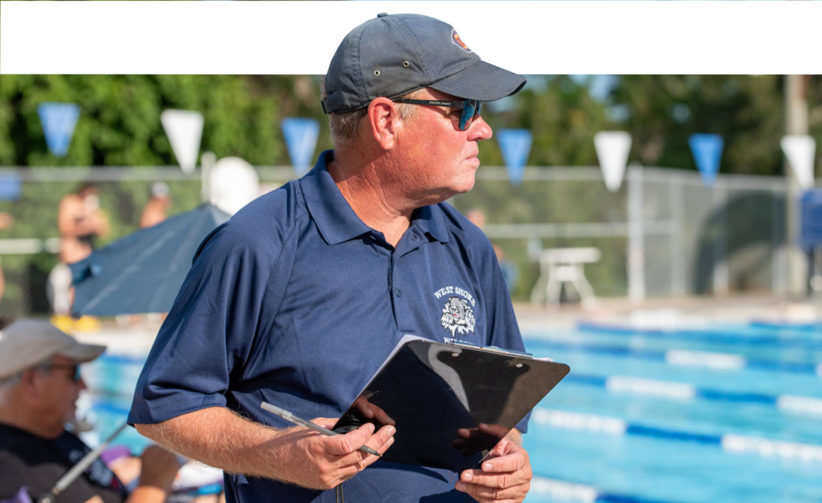 Head coach Randall Johnson observes his swimmers as they compete against Edgewood at Fee Avenue Pool on Sept 14.