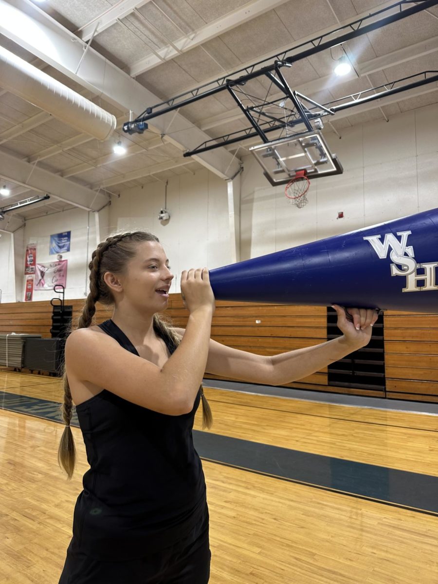Freshman Isabella Koch practices a cheer on Oct. 2.