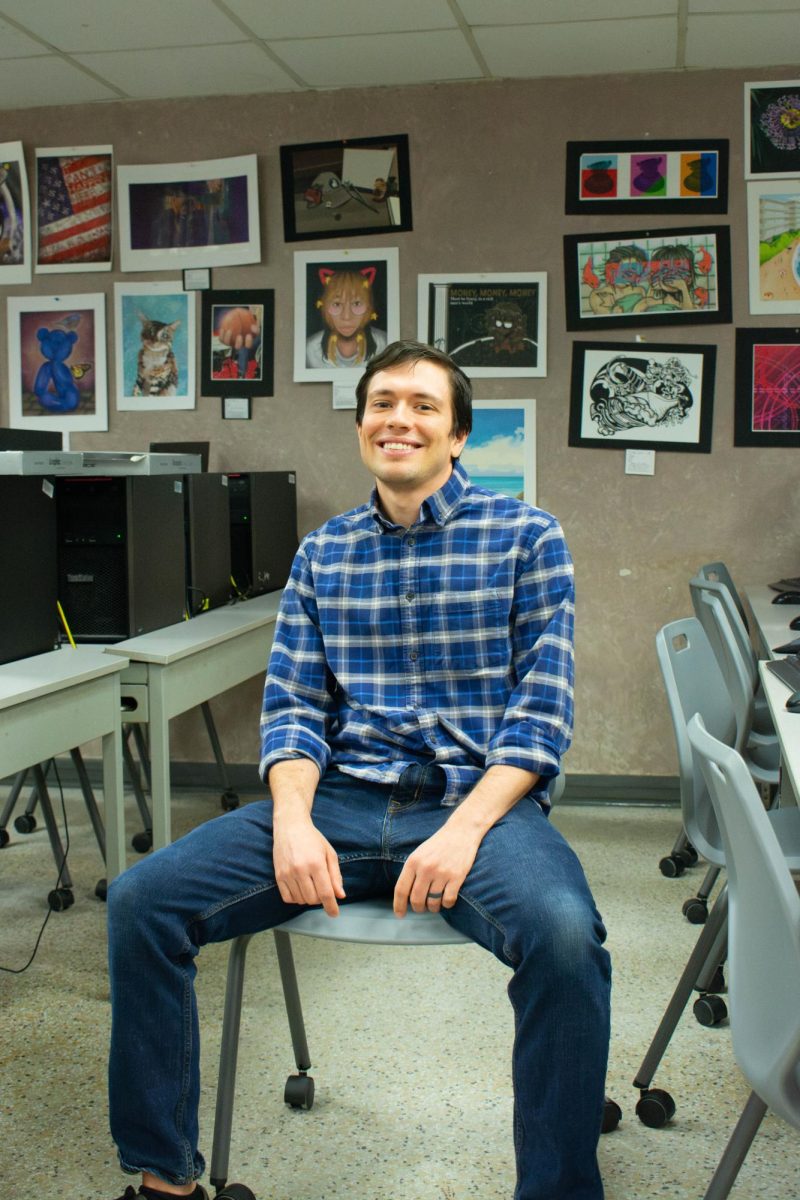 Michael Grover sits in the digital art room, where he took AP Digital Art with teacher James Finch more than 16 years ago.