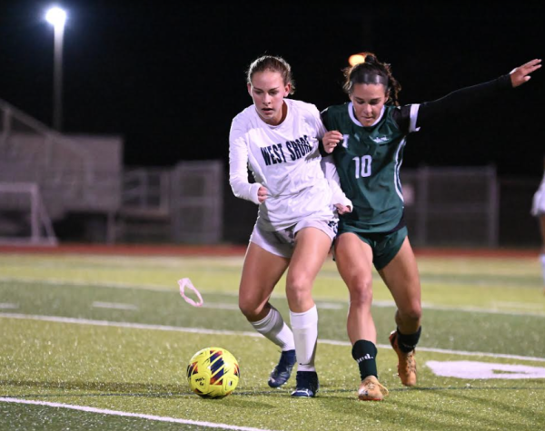 Eighth-grader Tana Burgreen  shields the ball from a Melbourne defender in a 3-0 away win on Nov. 29.  “I hate playing on turf,” Burgreen said. “It always cuts me up, and I feel more injury-prone.”