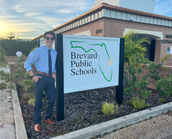 Senior Max Madl stands in front of the Brevard Public Schools building in Viera. 