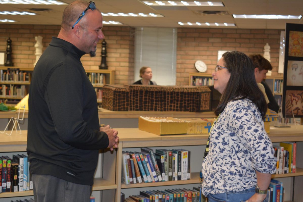 Burt Clark, future West Shore principal, talks to Spanish teacher Mrs. Stewart after announcing he will take over the position of principal following current principal Rick Flemings retirement. I think its really nice that we are going to have someone who is committed to being a Wildcat, Stewart said.