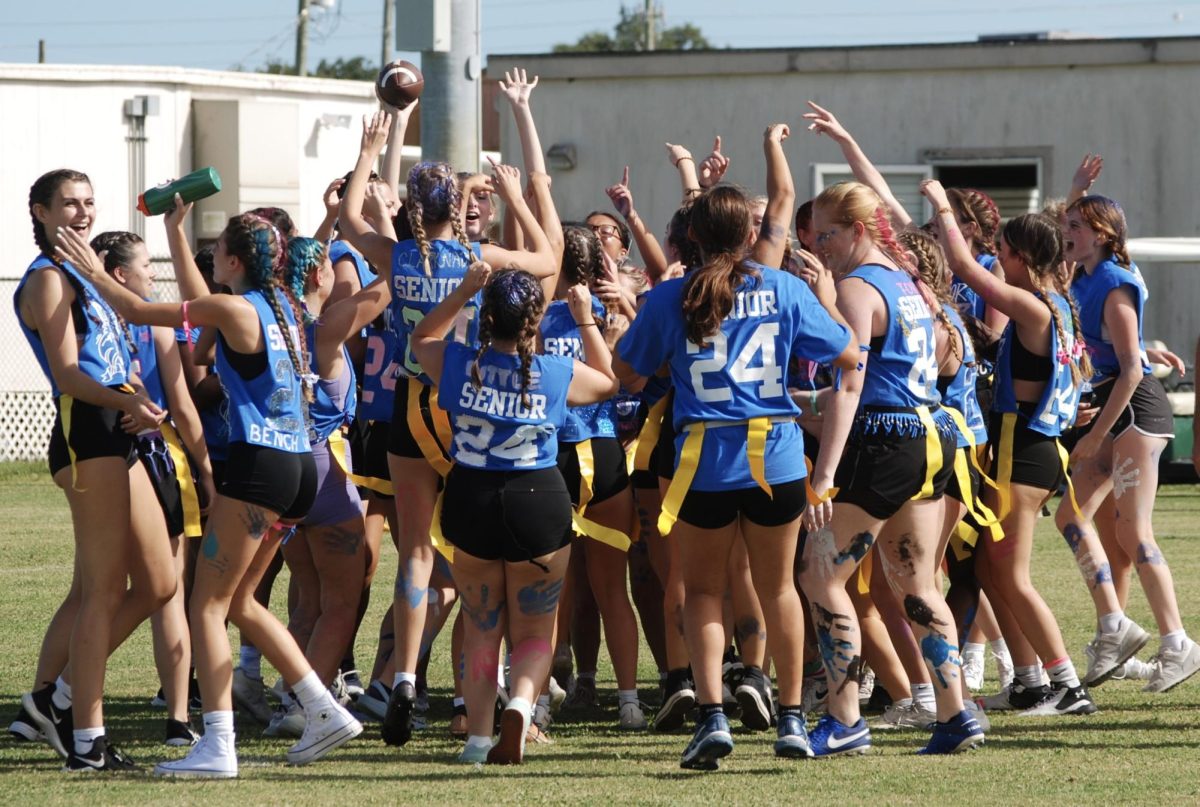 Senior girls cheer and celebrate after scoring a touchdown at Powderpuff on Sept. 21, 2023.