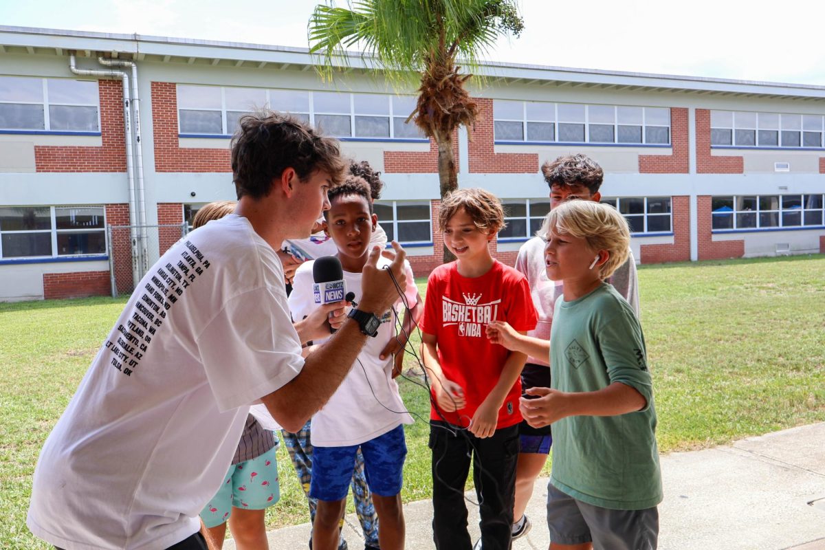 A group of 7th graders stop for an interview during the annual "Wildcats On the Prowl" scavenger hunt. “Well, I’m out numbered,” Resource Officer Butler said. “I did not realize we had so many seventh graders until today.”  