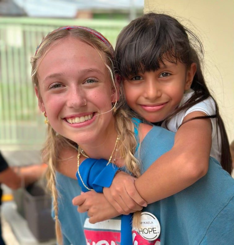 Volunteering at the Hope Center in Pavas, senior Mykaela Brown gives a young girl, Camila, a piggy-back ride.
"Camila would write our names next to each other and chalk with a heart around and that just really impacted me," Brown said.