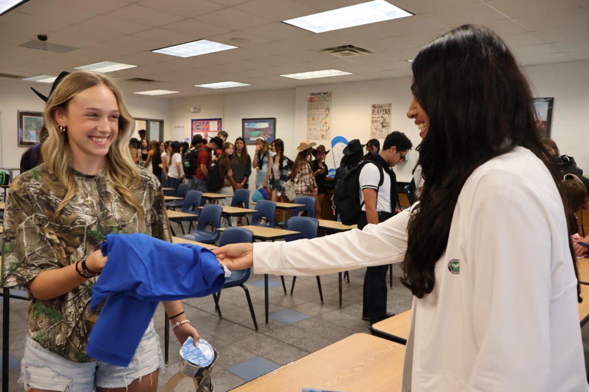 Senior Mykaela Brown picks up her powderpuff shirt on September 23. "I'm excited for powderpuff, it's going to be really good for the seniors," Brown said. "We've been working really hard for it."