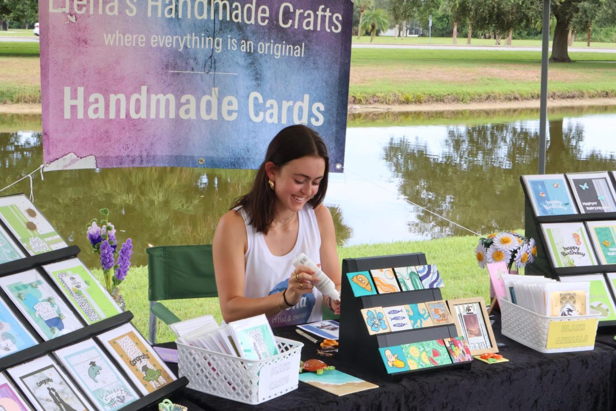 Senior Elena Weeks prepares specialized handmade cards for sale at the Viera East Woodside Farmers Market on Sept. 14. "A lot of times people will not only buy a card, but they’ll stop and have a conversation with me," Weeks said. "I really enjoy that aspect of it because I get to know the customer."