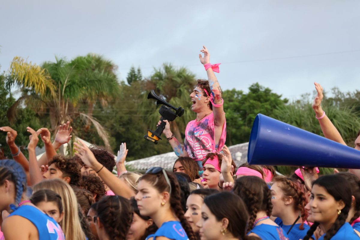 Senior Matthew Tucker blasts an air horn during the early morning Powderpuff rally. “I’m 100% confident that we’re going to win today,” Tucker said. “We have the most athletic girls in the school.”