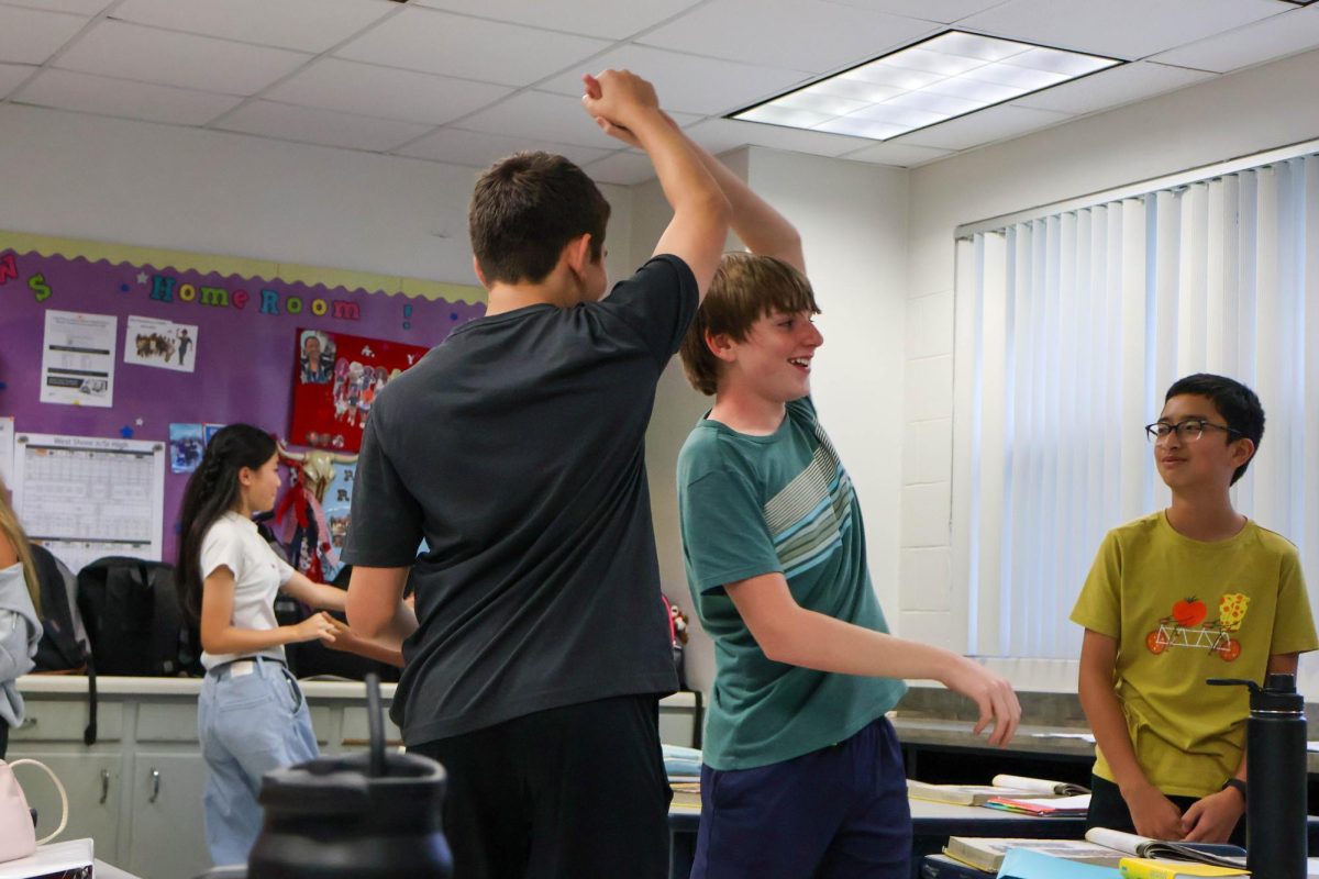 Eighth-graders Anil Mahindra and Daniel Sorgenfrei learn how to do the Merengue dance in Spanish teacher Mireya Ramos' classroom on Sept. 13. "Merengue highlights the Dominican culture," Ramos said. "Every Friday we cover a different dance to learn about a different culture."