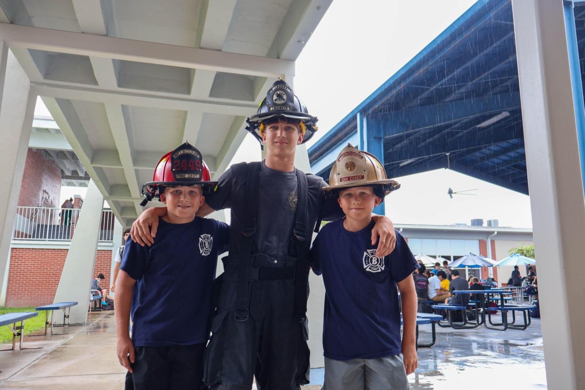 Three brothers, freshman Brodie Simmons and seventh graders Easton and Reed, wear their dad's fire department gear for "hometown hero" day during spirit week on Sept. 25. "My dad is a fireman and I wanted to show my appreciation towards all that he and his team do," Simmons said.