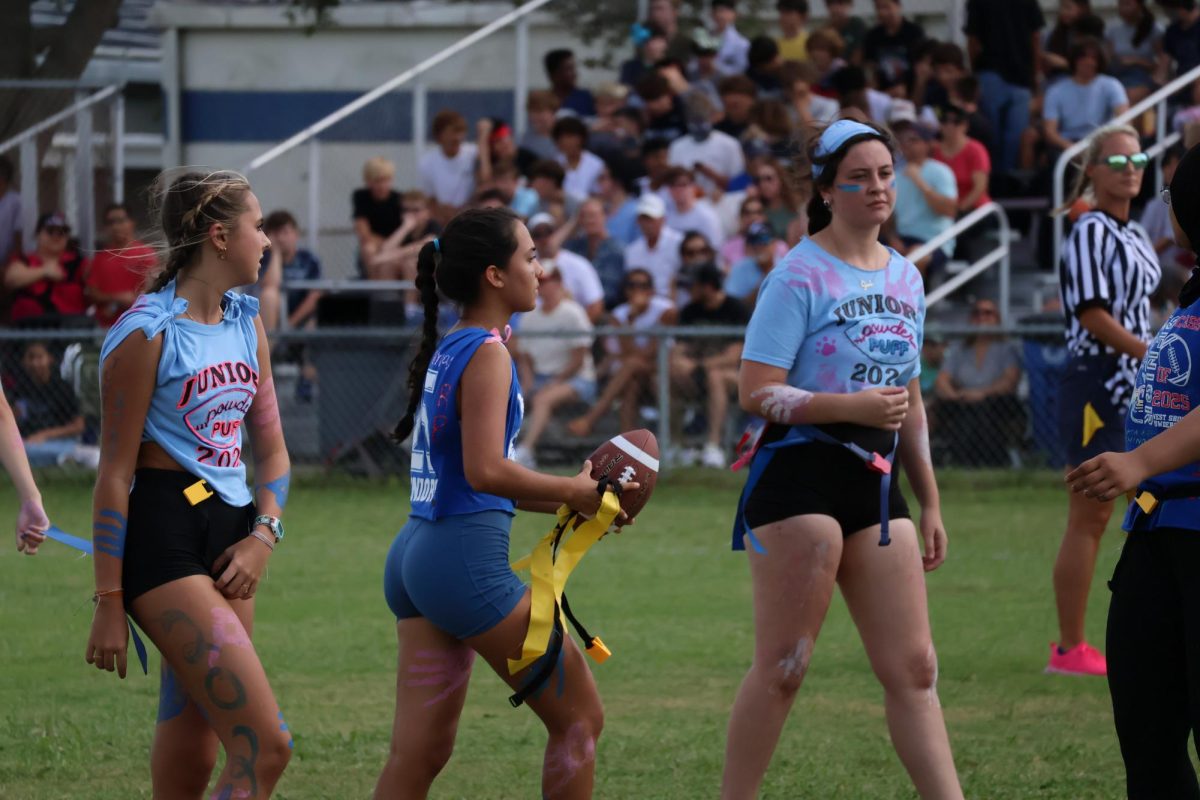 From left, junior Brooke Hartford, senior Allison Gunnell and junior Sarah McCray play in the annual Powder Puff game on Sept. 27. For the first time, girls flag football is an official sport at West Shore, and tryouts are scheduled to take place on Jan. 27.